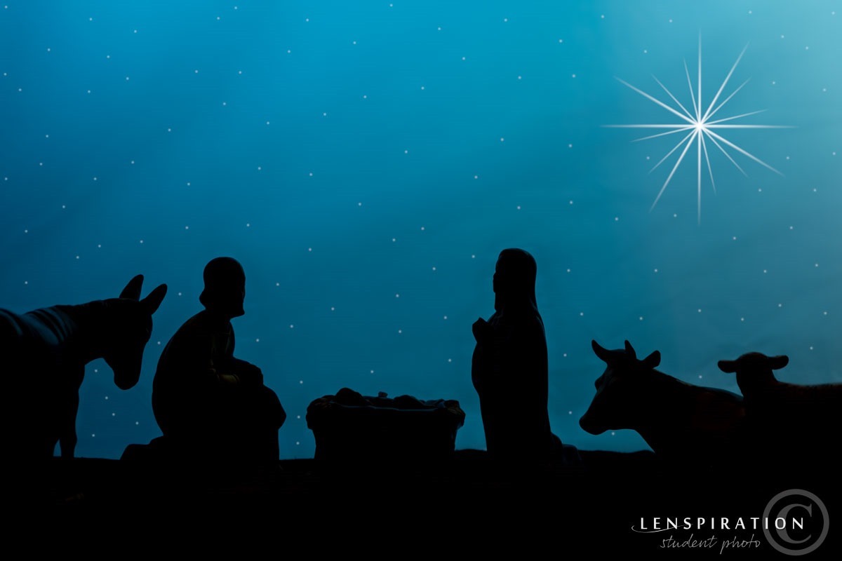 a silhouette of the creche with a stary sky and star of bethlehem