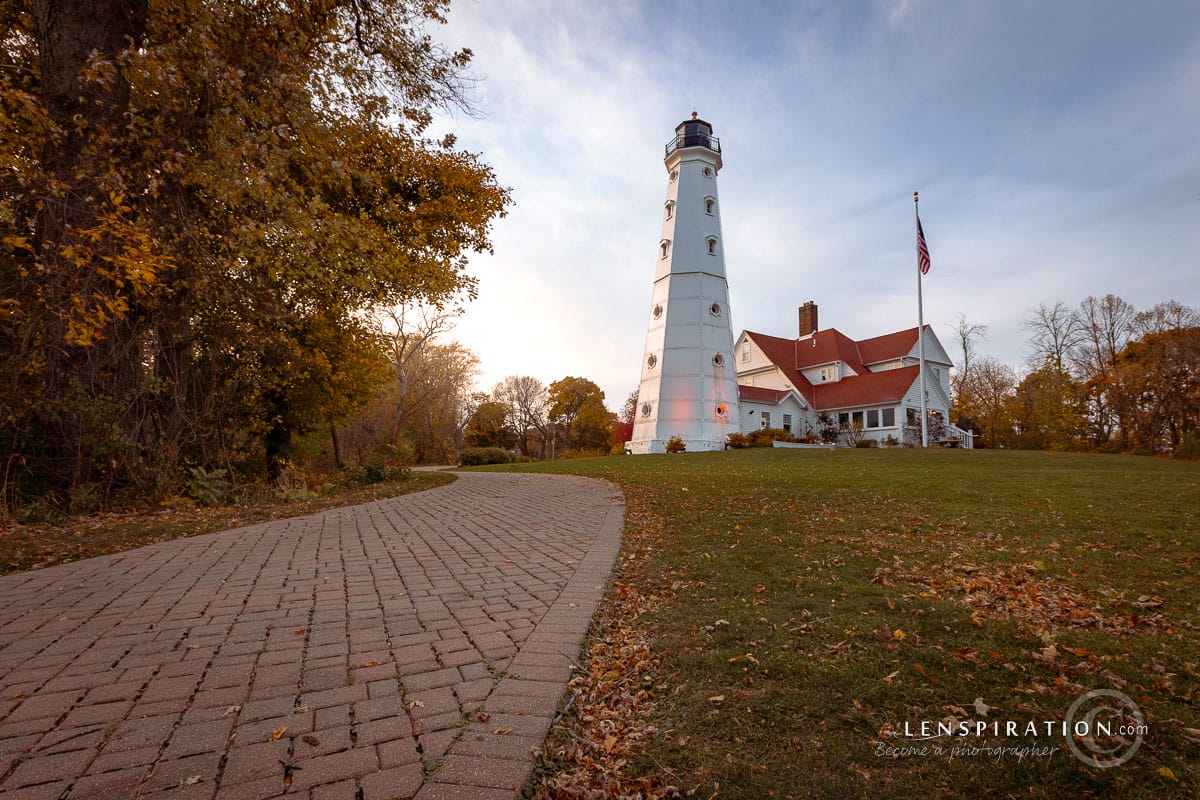 Another angle of a white and red lighthouse on the Wisconsin coast in autumn