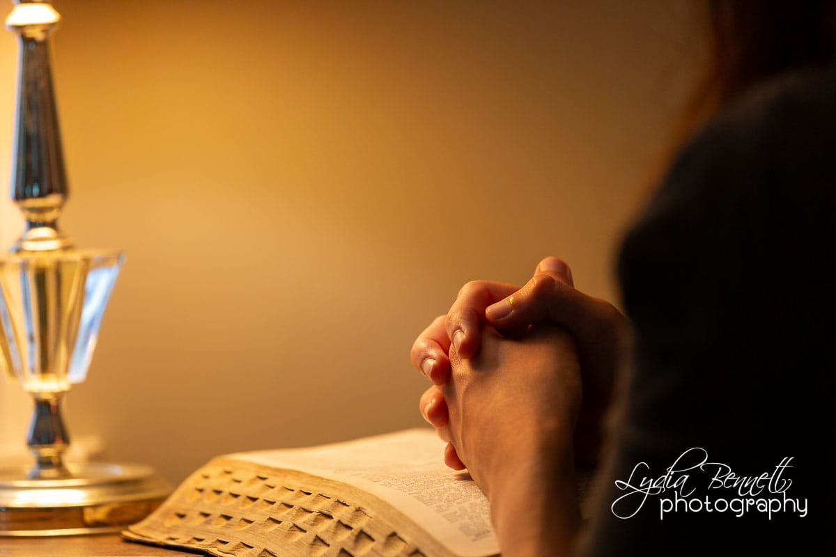 Cozy prayer time with Bible and lamp