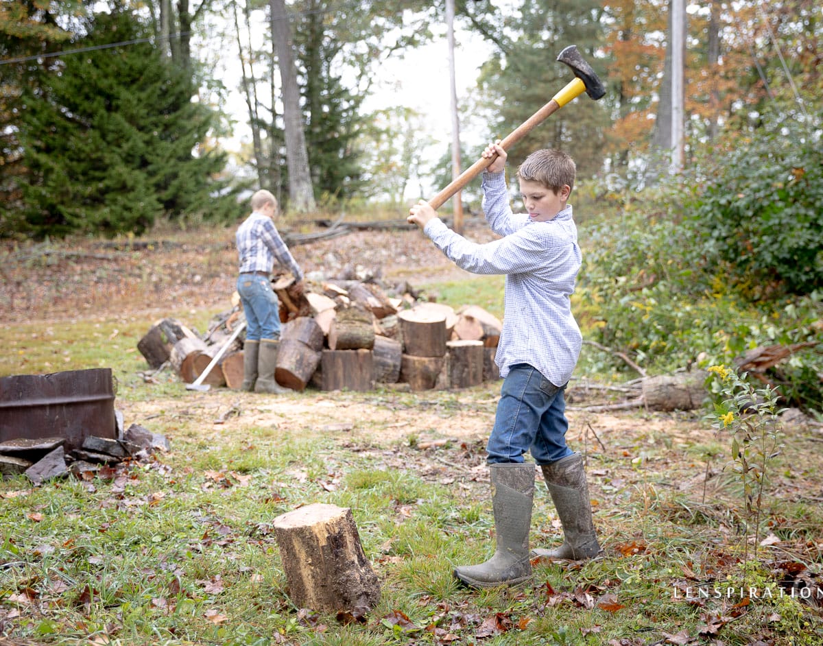 Homesteading boys split wood in the country in West Virginia