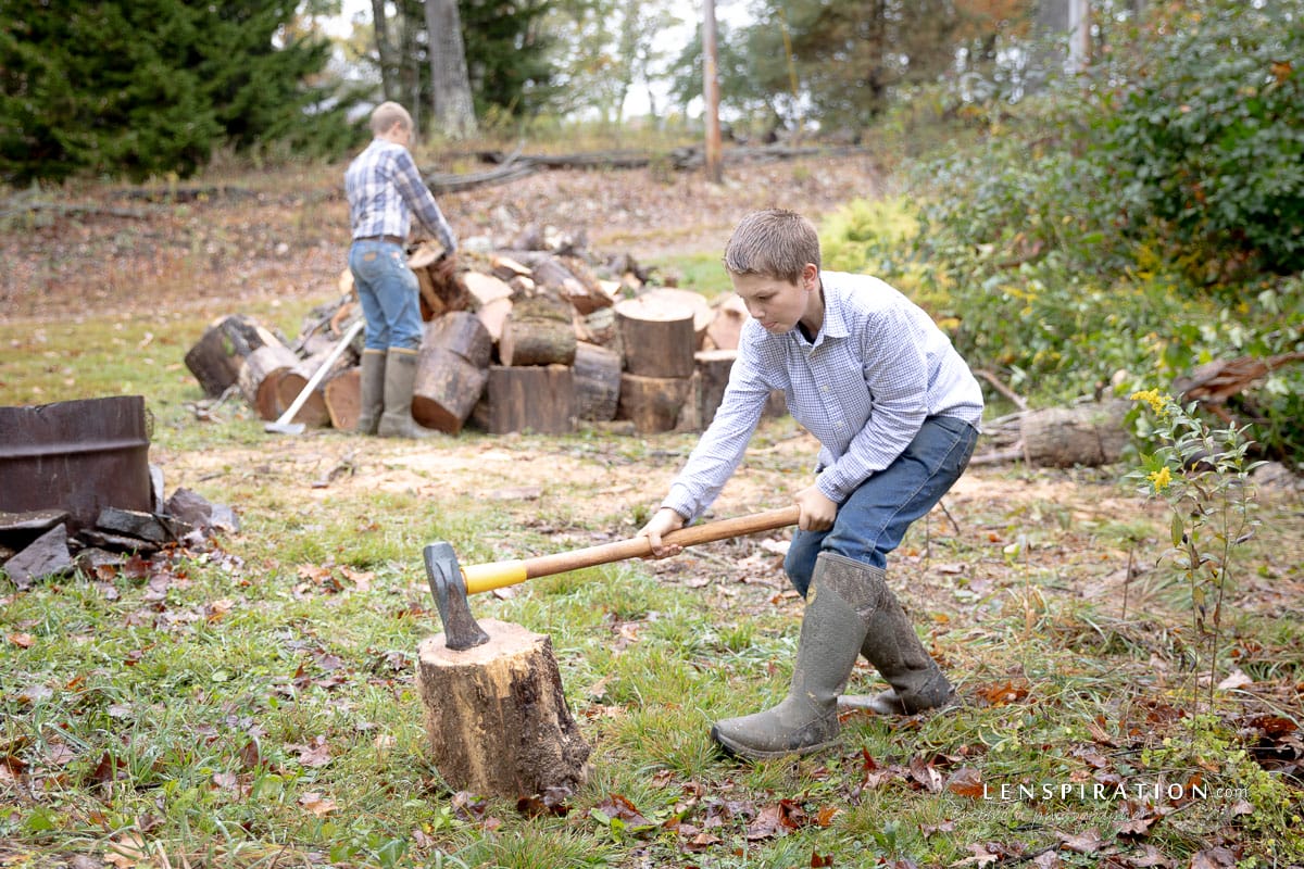 Homesteading boys split wood in the country in West Virginia