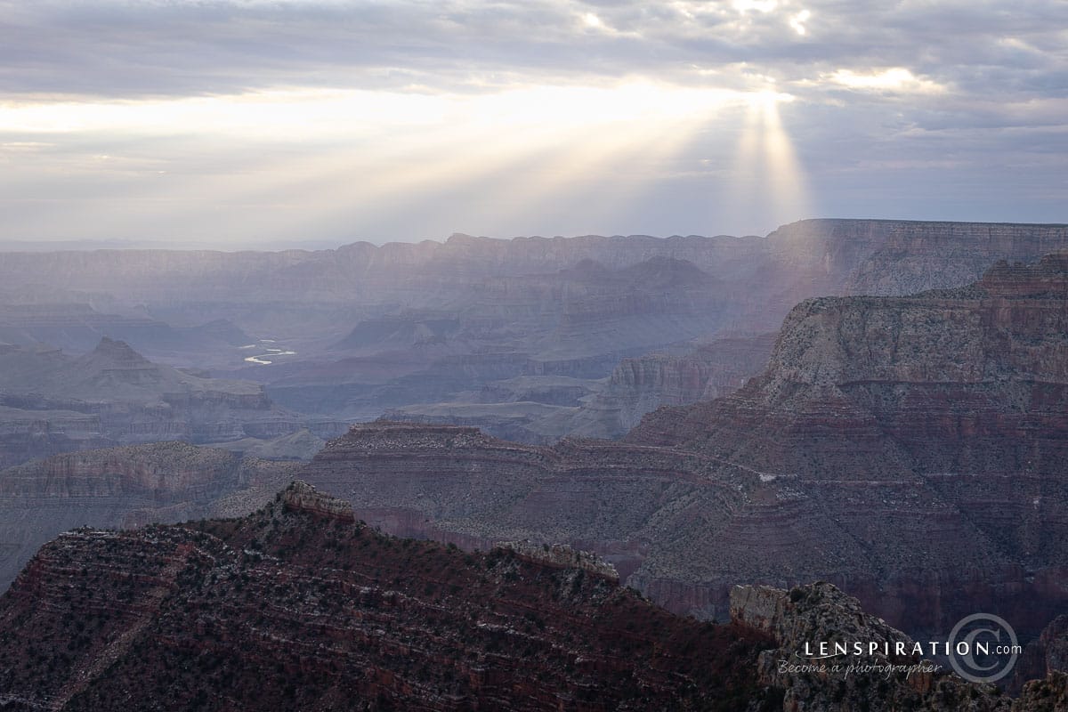 Sunlight peeking through the clouds, shining through the smokey atmosphere caused by the summer 2025 wildfires at Grand Canyon